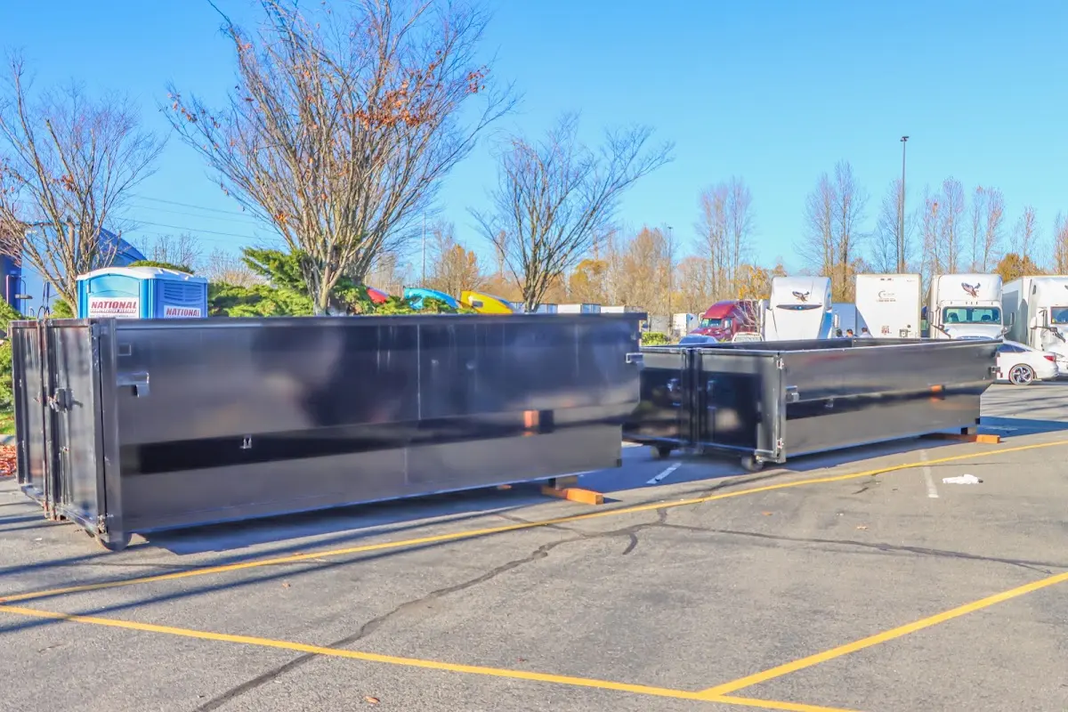 Professional dumpster rental service with roll-off container on residential driveway in Alamogordo